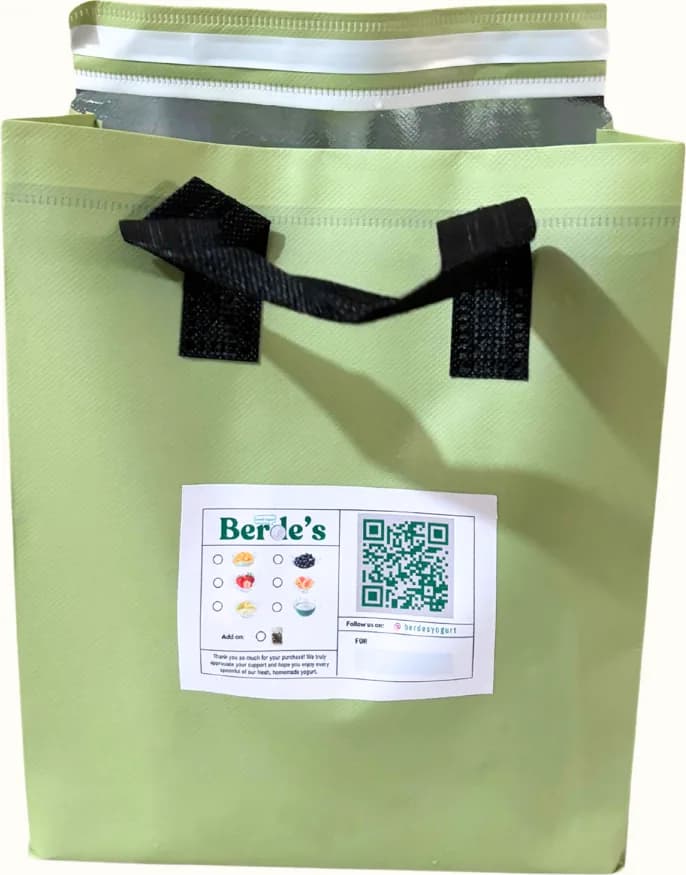 The wider thermal bag, sealed, with its order label on the front.