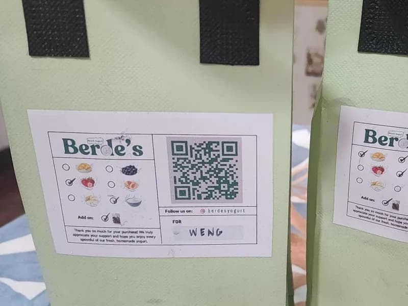 Two green Berde's delivery bags with order slips taped on, both addressed to Weng.